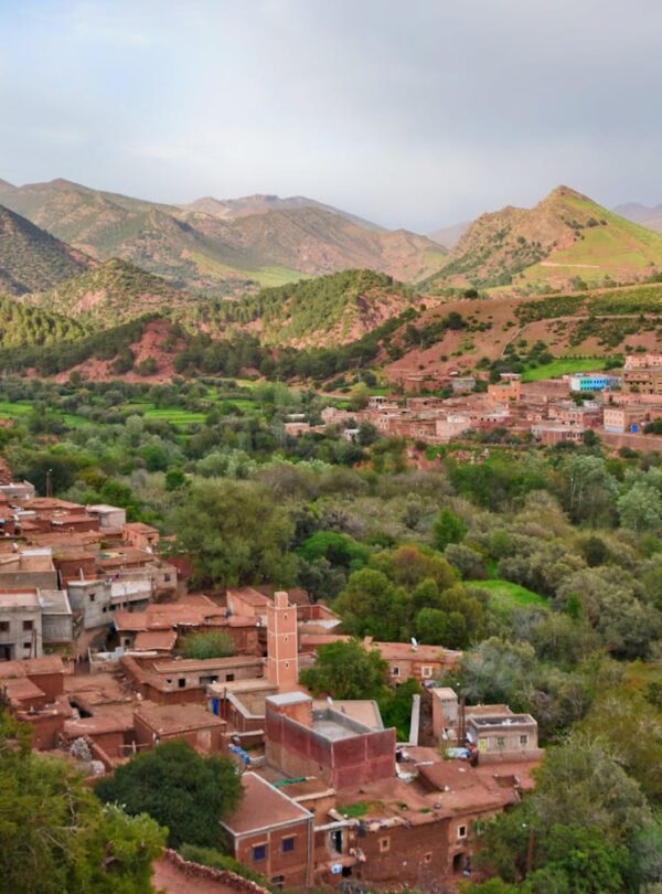 Scenic aerial view of Ait Barka village amidst lush green valleys and rugged mountains.morocco travel morocco 9 days tour from casablanca