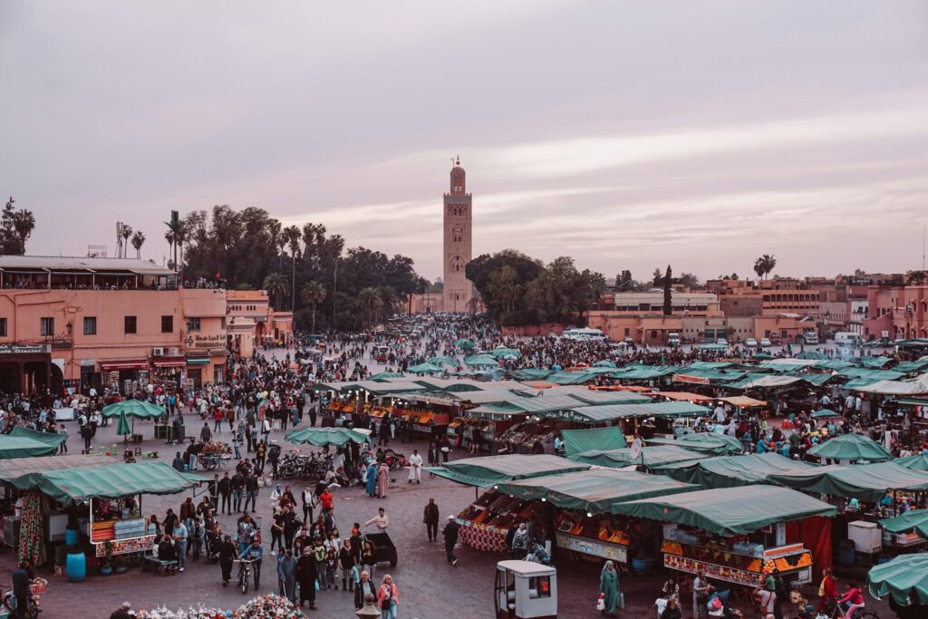 people walking on street near buildings during daytime, Morocco ravel ,12 days tour from Casablanca